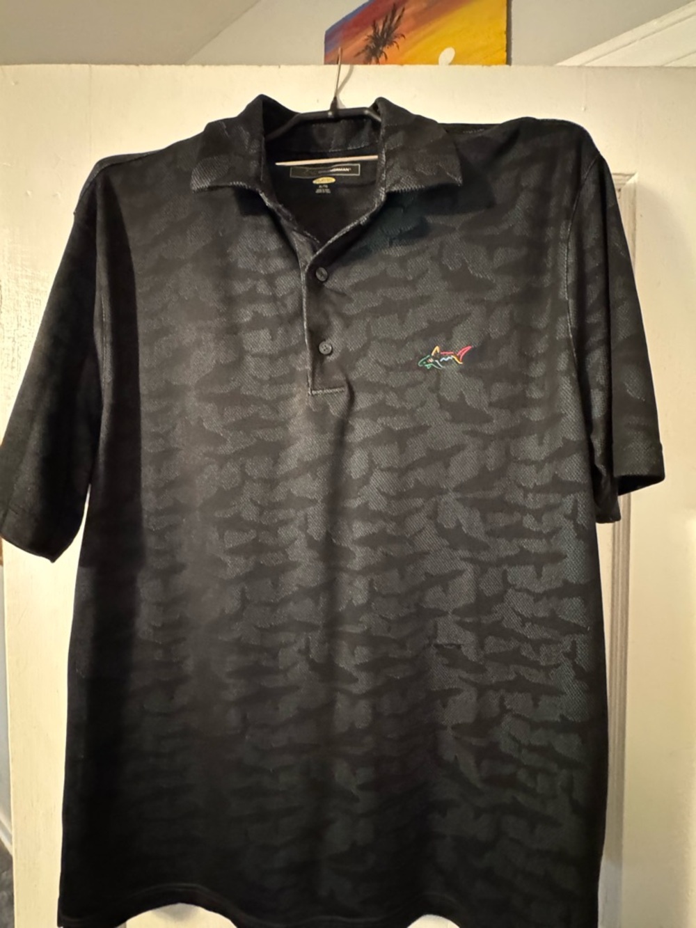 Greg Norman Collection Black Polo with Subtle Pattern and Multicolor Shark Logo